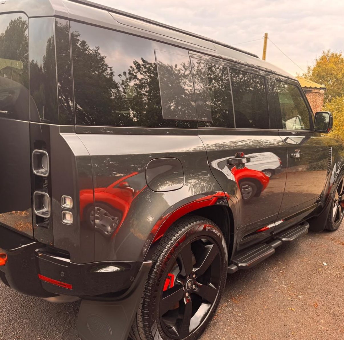 Grey Land Rover Defender with red details