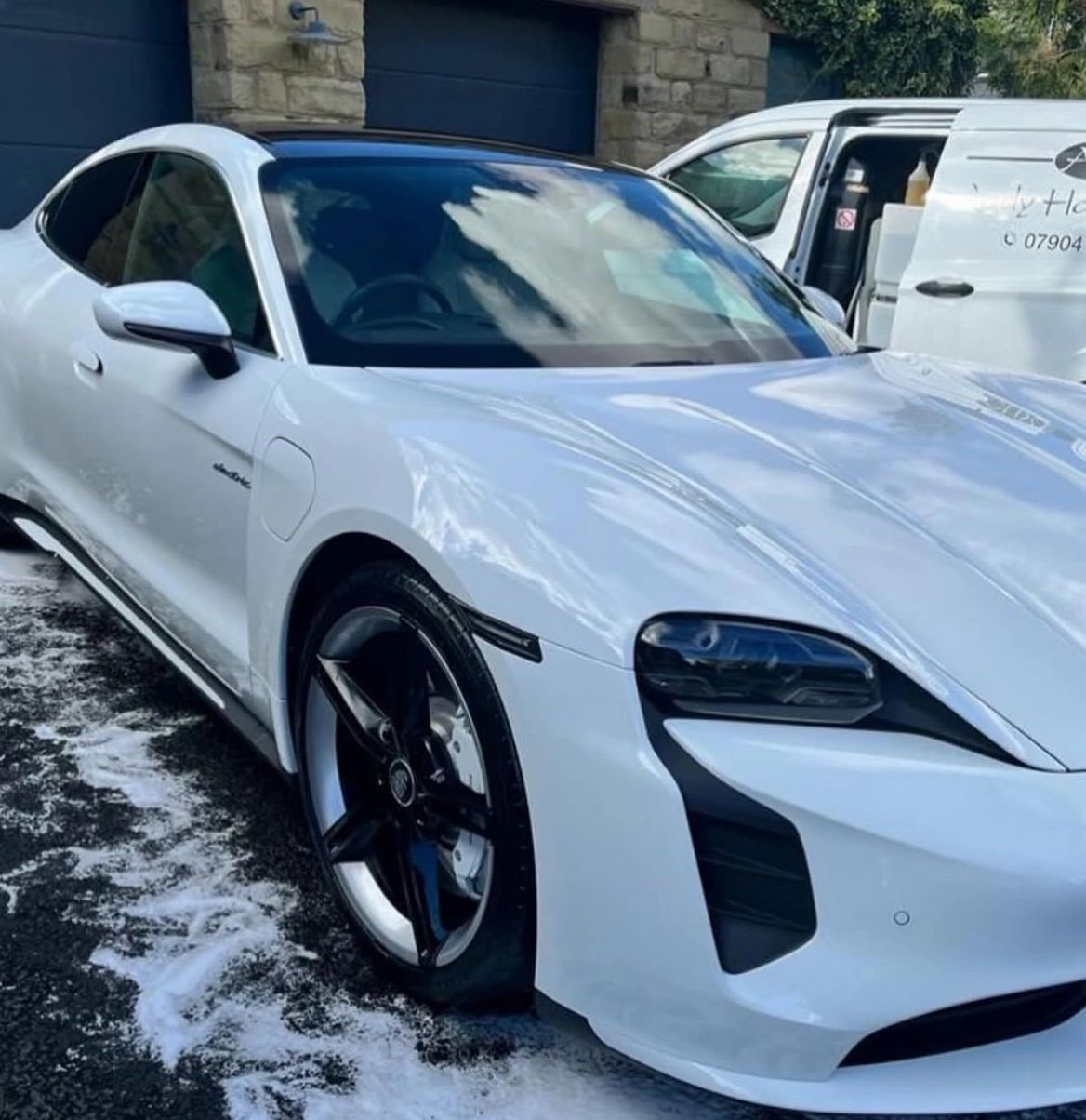 White Porsche Taycan valeted on a customer's drive